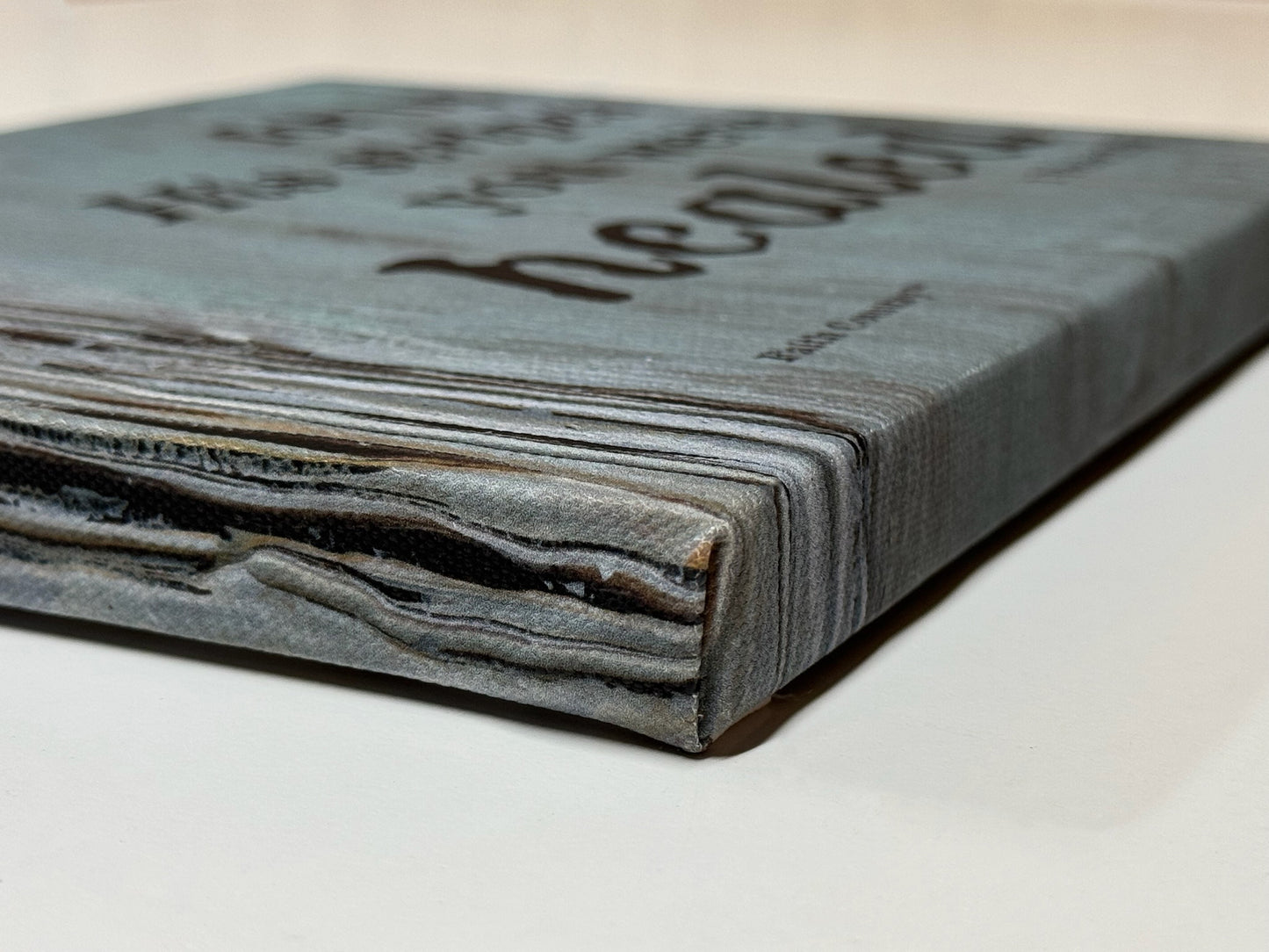 Side view of a wrapped canvas displaying the scripture 'For by His stripes you were healed - 1 Peter 2:24,' highlighting the textured background and rustic design.