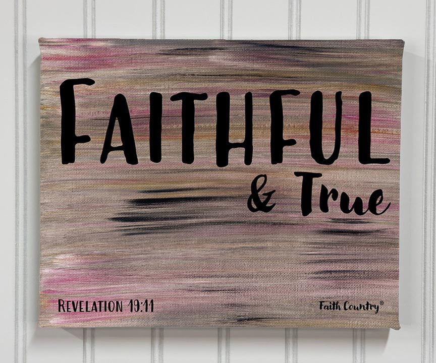Canvas wall art with the words ‘Faithful & True’ in bold black typography, based on Revelation 19:11. Neutral background with pink and gray strokes.