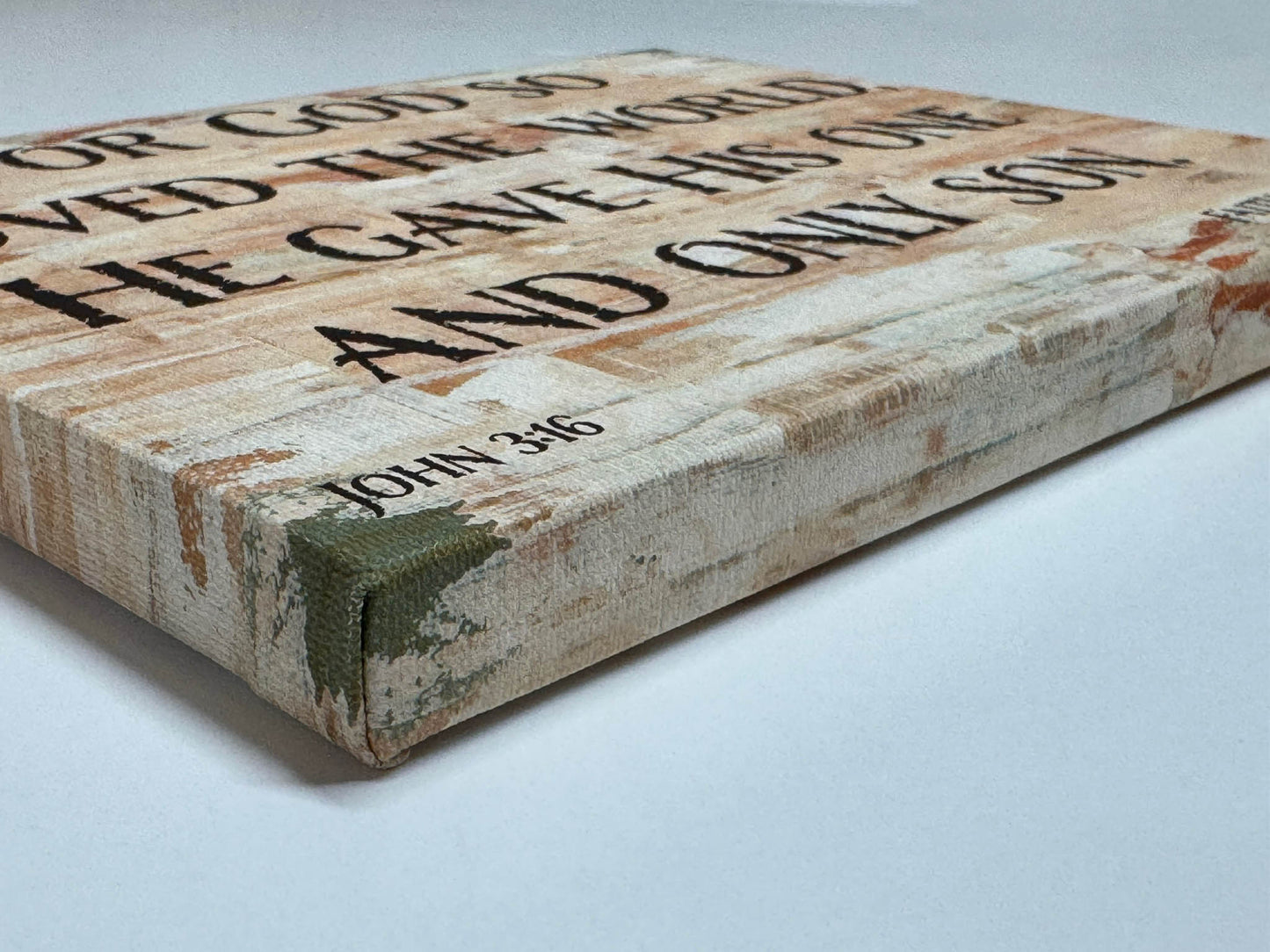 Close-up angled view of canvas edge showing textured gallery wrap and painted sides of John 3:16 scripture wall art.