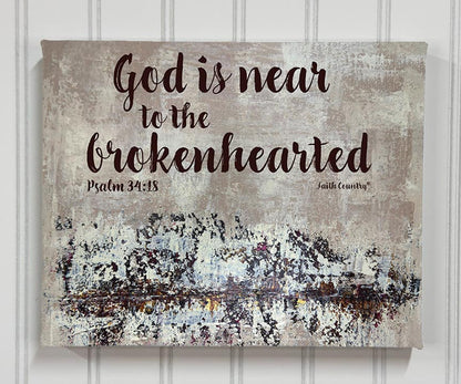 Canvas wall art print with Psalm 34:18 scripture 'God is near to the brokenhearted' displayed on a textured neutral background, styled with a vintage aesthetic.