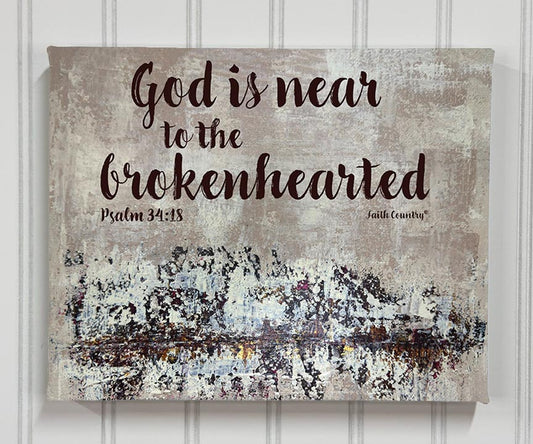 Canvas wall art print with Psalm 34:18 scripture 'God is near to the brokenhearted' displayed on a textured neutral background, styled with a vintage aesthetic.