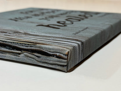 Side view of a wrapped canvas displaying the scripture 'For by His stripes you were healed - 1 Peter 2:24,' highlighting the textured blue-gray edges and rustic design.