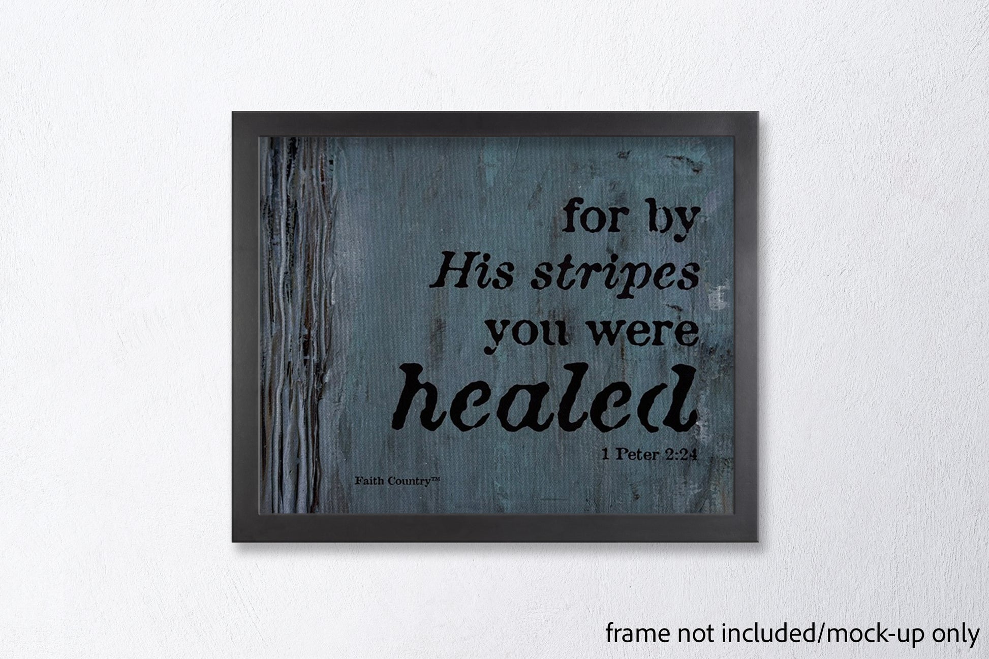 Mockup of 'For by His stripes you were healed - 1 Peter 2:24' scripture wall art in a sleek black frame against a clean white wall. Frame not included.