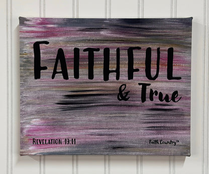 Christian wall art featuring the words 'Faithful & True' from Revelation 19:11 in bold black text, set on a pink, gold, and black abstract streaked background. Modern and spiritual decor.