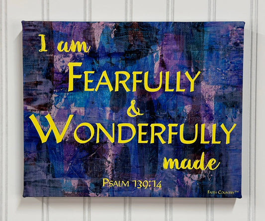 Christian wall art with the text 'I am fearfully & wonderfully made' from Psalm 139:14 in bold yellow font on a textured blue and purple abstract background. Inspirational decor.