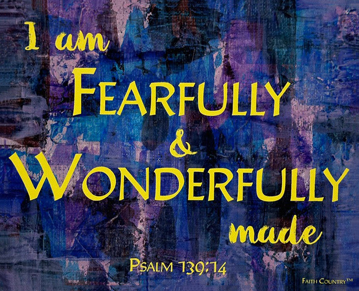 Close-up of scripture-inspired canvas art featuring 'I am fearfully & wonderfully made' in bright yellow text, set on a textured blue and purple abstract background.