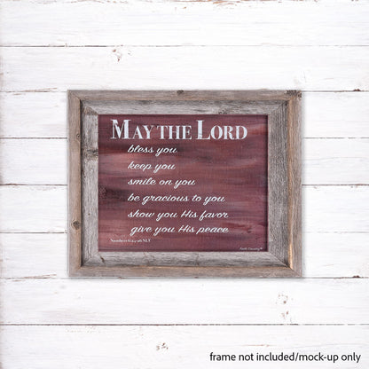 Mock-up of 'May the Lord' scripture canvas print displayed in a rustic wooden frame (frame not included) against a white wooden background.