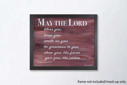 Mock-up of 'May the Lord' scripture canvas print in a sleek black frame (frame not included) styled against a modern white wall.