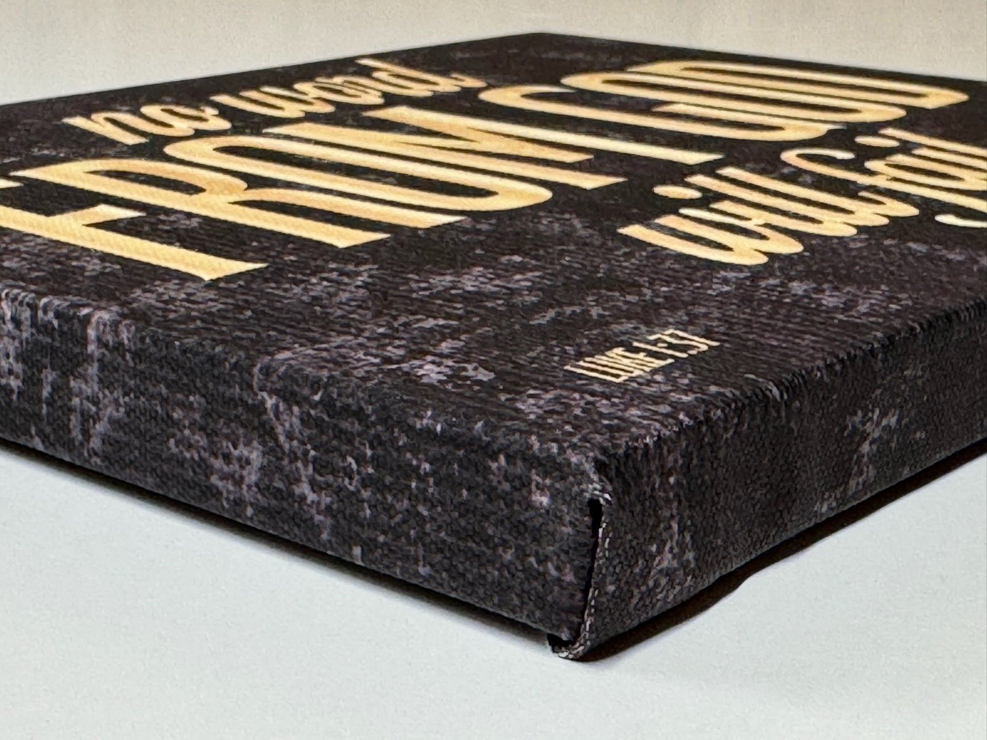 Angled photo of canvas edge showing premium texture and gallery wrap finish.