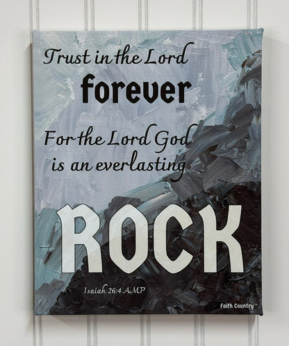 Faith-based wall art featuring the scripture 'Trust in the Lord forever, for the Lord God is an everlasting Rock' from Isaiah 26:4, displayed on a textured abstract blue and gray background. Rustic Christian decor.